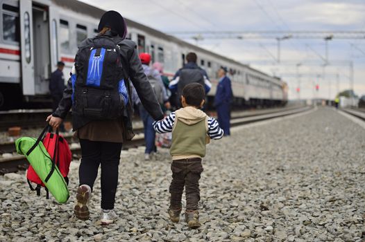 October 5, 2015; Tovarnik in Croatia. Croatian police assist refugees get into train which will go to Hungary.