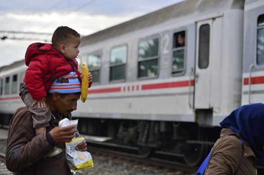 October 5, 2015; Tovarnik in Croatia. Croatian police assist refugees get into train which will go to Hungary.