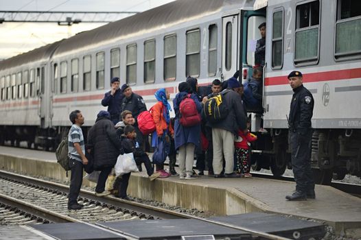 October 5, 2015; Tovarnik in Croatia. Croatian police assist refugees get into train which will go to Hungary.