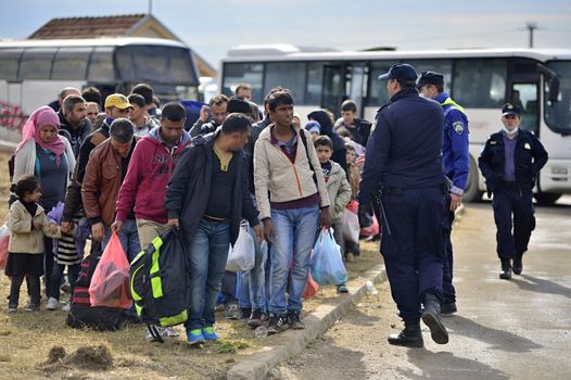 October 5, 2015; Tovarnik in Croatia. Croatian police assist refugees get into train which will go to Hungary.