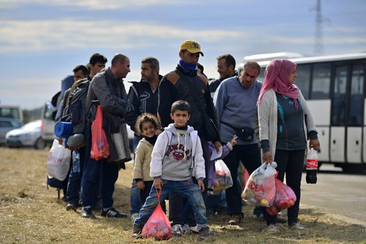October 5, 2015; Tovarnik in Croatia. Croatian police assist refugees get into train which will go to Hungary.