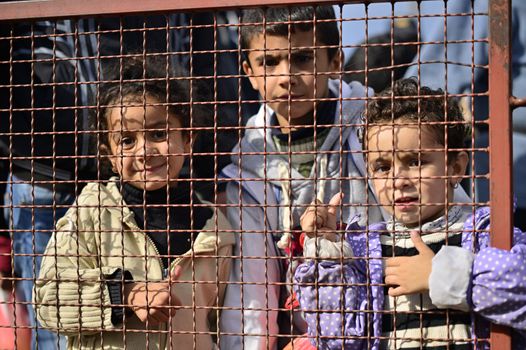 October 5, 2015; Tovarnik in Croatia. Croatian police assist refugees get into train which will go to Hungary.