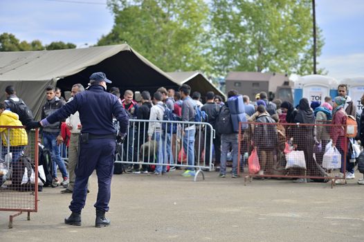 October 5, 2015; Tovarnik in Croatia. Croatian police assist refugees get into train which will go to Hungary.