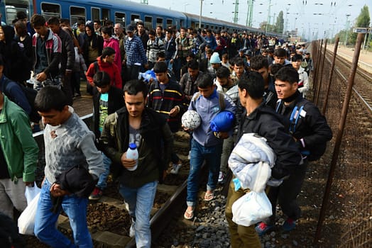 October 6,2015; Hegyeshalom in Hungary. Group of refugees leaving Hungary. They came to Hegyeshalom by train and then they leaving Hungary and go to Austria and then to Germany. Many of them escapes from home because of civil war. 