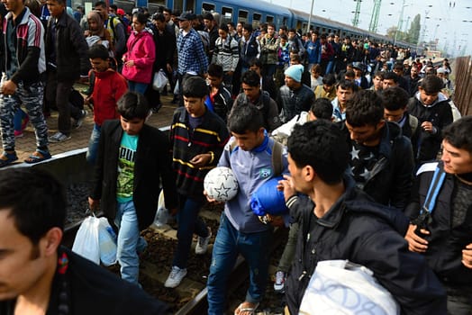 October 6,2015; Hegyeshalom in Hungary. Group of refugees leaving Hungary. They came to Hegyeshalom by train and then they leaving Hungary and go to Austria and then to Germany. Many of them escapes from home because of civil war. 