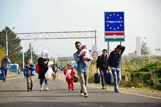 October 6,2015; Hegyeshalom in Hungary. Group of refugees leaving Hungary. They came to Hegyeshalom by train and then they leaving Hungary and go to Austria and then to Germany. Many of them escapes from home because of civil war. 