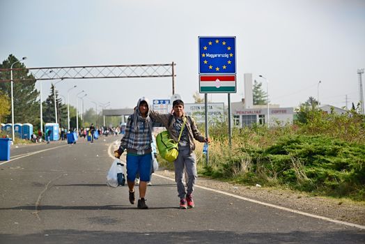 October 6,2015; Hegyeshalom in Hungary. Group of refugees leaving Hungary. They came to Hegyeshalom by train and then they leaving Hungary and go to Austria and then to Germany. Many of them escapes from home because of civil war. 