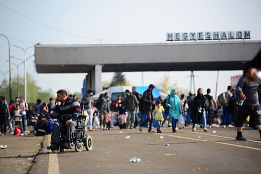 October 6,2015; Hegyeshalom in Hungary. Group of refugees leaving Hungary. They came to Hegyeshalom by train and then they leaving Hungary and go to Austria and then to Germany. Many of them escapes from home because of civil war. 
