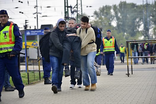 October 6,2015; Hegyeshalom in Hungary. Group of refugees leaving Hungary. They came to Hegyeshalom by train and then they leaving Hungary and go to Austria and then to Germany. Many of them escapes from home because of civil war. 