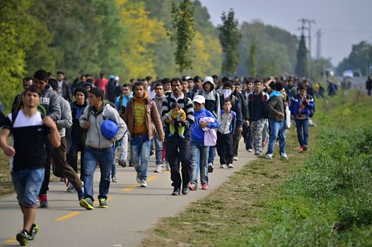 October 6,2015; Hegyeshalom in Hungary. Group of refugees leaving Hungary. They came to Hegyeshalom by train and then they leaving Hungary and go to Austria and then to Germany. Many of them escapes from home because of civil war. 