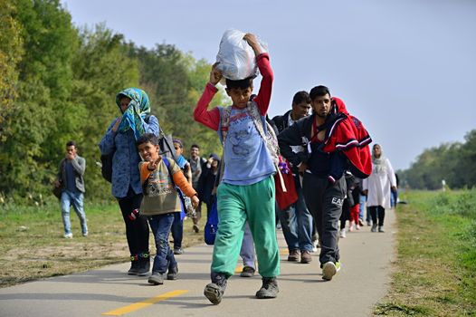 October 6,2015; Hegyeshalom in Hungary. Group of refugees leaving Hungary. They came to Hegyeshalom by train and then they leaving Hungary and go to Austria and then to Germany. Many of them escapes from home because of civil war. 