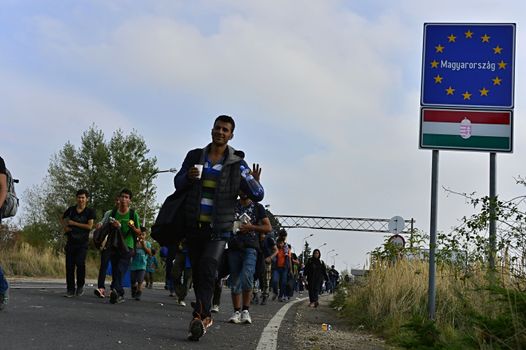 October 6,2015; Hegyeshalom in Hungary. Group of refugees leaving Hungary. They came to Hegyeshalom by train and then they leaving Hungary and go to Austria and then to Germany. Many of them escapes from home because of civil war. 