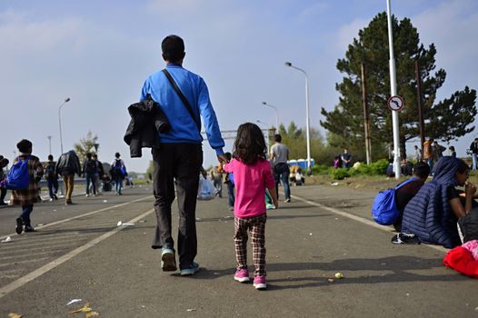 October 6,2015; Hegyeshalom in Hungary. Group of refugees leaving Hungary. They came to Hegyeshalom by train and then they leaving Hungary and go to Austria and then to Germany. Many of them escapes from home because of civil war. 