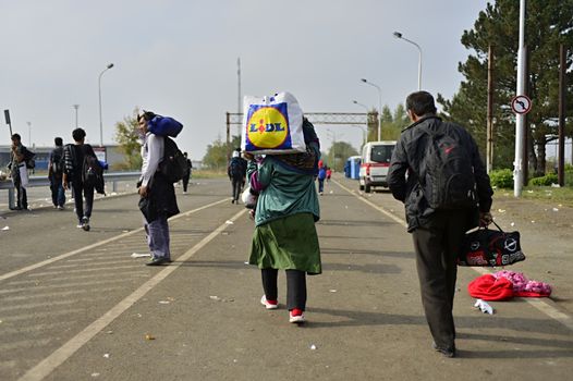 October 6,2015; Hegyeshalom in Hungary. Group of refugees leaving Hungary. They came to Hegyeshalom by train and then they leaving Hungary and go to Austria and then to Germany. Many of them escapes from home because of civil war. 