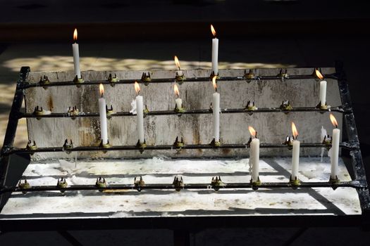 Burning white candles in church