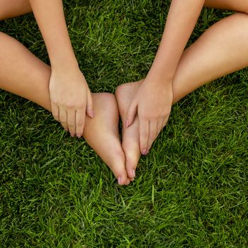 Close-up of female legs over the grass