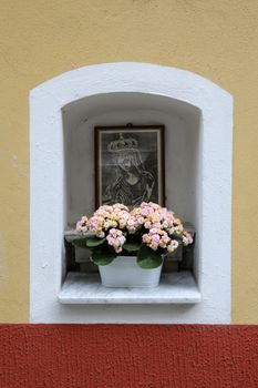 Manarola Italy, Liguria, Cinque Terre, a religious chantry with a Madonna statue in one of the streets of the center