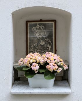 Manarola Italy, Liguria, Cinque Terre, a religious chantry with a Madonna statue in one of the streets of the center