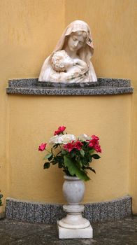 The statue of Madonna with the Child in front of the Church of the Holy Sacrament in Portoferraio, Elba, Italy