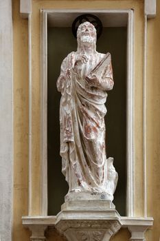 St. John the Evangelist on the facade of the Church of Mercy in Portoferraio, Elba, Italy