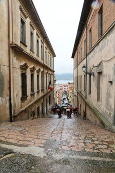 Tourists walking up stairs in street on May 03, 2014 Portoferraio, Italy