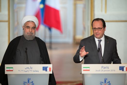 FRANCE, Paris : French President Francois Hollande (R) and Iranian President Hassan Rouhani give a joint press conference on January 28, 2016 at the Elysee presidential Palace in Paris.President Hassan Rouhani hailed a new relationship between Iran and France during a visit that saw the signing of a host of post-sanctions business deals. 