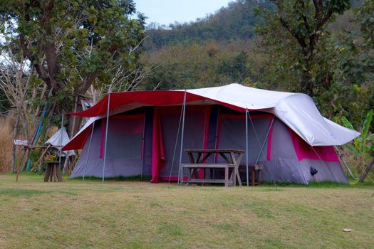 Tourist tent in camp among meadow in the mountain