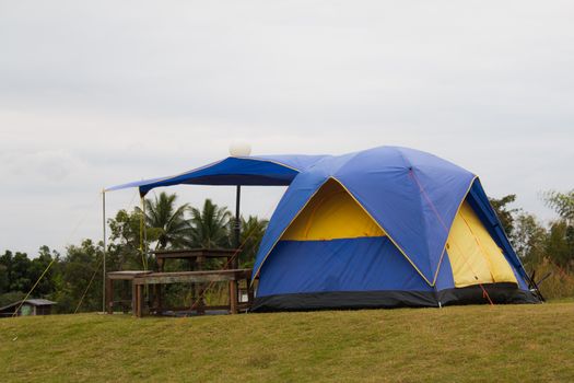 Tourist tent in camp among meadow in the mountain