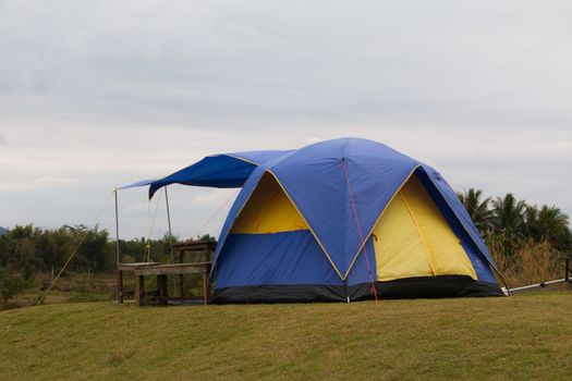 Tourist tent in camp among meadow in the mountain