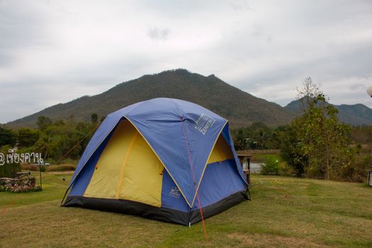 Tourist tent in camp among meadow in the mountain