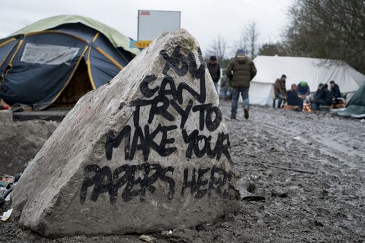 FRANCE, Grande-Synthe: A message written on a rock reads 'you can try to make you papers here' in the camp in Grande-Synthe, northern France on January 29, 2016.