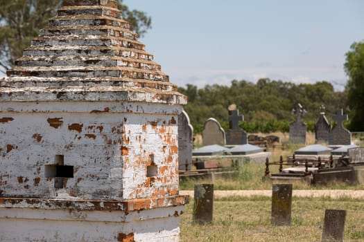 Rural cemetery with old chinese tombs and burials in the background.