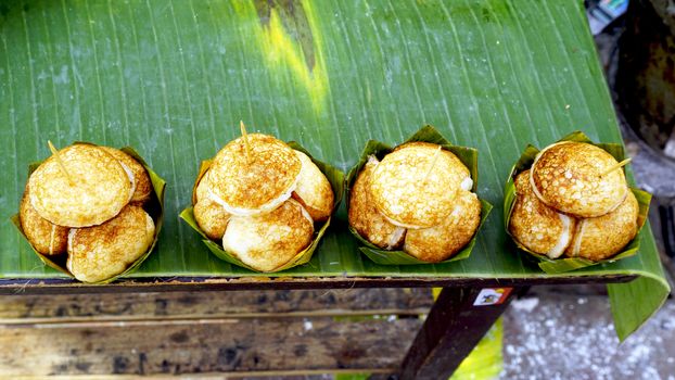 Sweet and Savory Grilled Coconut-Rice Hotcakes, Coconut Rice Cake on banana packaging, Asian dessert, Thai, Thailand, Luang Prabang, Laos