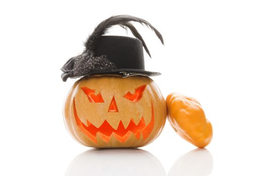 Creepy halloween pumpkin with hat isolated on white background. Traditional american halloween decoration.
