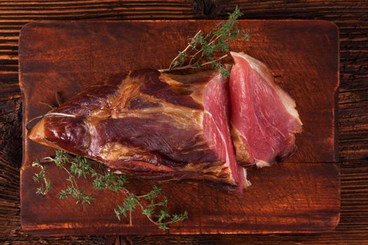 Traditional smoked meat on wooden table. Culinary meat eating. 