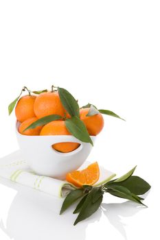 Fresh ripe mandarines in white bowl isolated on white background. Healthy fruit eating. 