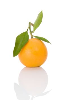 One delicious orange with green leaves isolated on white background. Healthy fruit eating. 