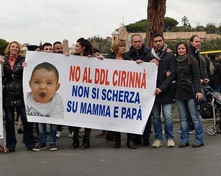 ITALY, Rome: Italians hold a sign that reads: 'No to the bill Cirinna, do not mess up Mom and Dad' as they gather in Rome's Circus Maximus arena on January 30, 2016 to protest against a civil unions bill for same-sex couples. The rally's organizers framed the protest as a 'family day' celebration in support of traditional marriage and has been backed by some members of the Catholic church. Lawmakers will vote next week on proposals that will allow gay couples with civil unions, and unmarried heterosexual couples, the same rights as they would have under marriage. Italy is the only nation in Western Europe that does not recognize same sex civil unions or gay marriage. 
