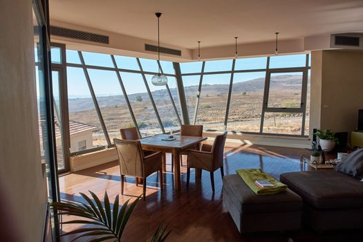 Modern interior design living room with huge panoramic windows that allow the landscape in                        