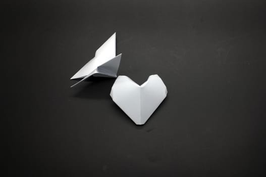White origami butterfly and heart shape paper