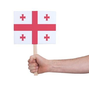 Hand holding small card, isolated on white - Flag of Georgia