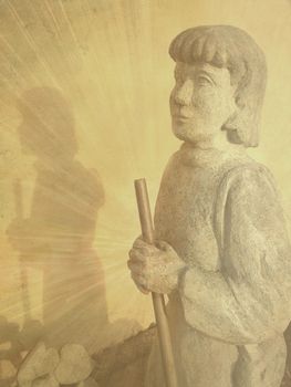 Statue of a humble and praying pilgrim outside of the Sancta Birgitta monastery in Vadstena Sweden.