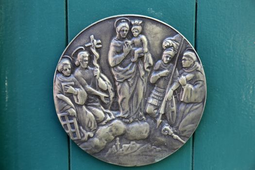 Virgin Mary with Baby Jesus and Saints, relief at home in Portofino, Italy