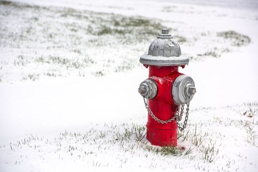 A red fire hydrant burried in snow