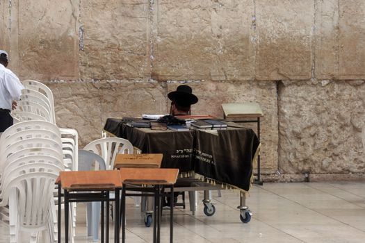 Jewish men pray at the western wall October 03, 2006 in Jerusalem, IL. The wall is one of the holiest sites in Judaism attracting thousands of worshipers daily.