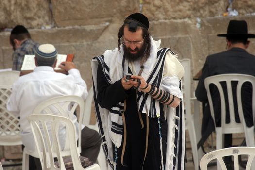 Jewish men pray at the western wall October 03, 2006 in Jerusalem, IL. The wall is one of the holiest sites in Judaism attracting thousands of worshipers daily.