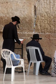 Jewish men pray at the western wall October 03, 2006 in Jerusalem, IL. The wall is one of the holiest sites in Judaism attracting thousands of worshipers daily.