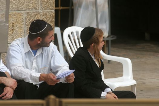 Jewish men pray at the western wall October 03, 2006 in Jerusalem, IL. The wall is one of the holiest sites in Judaism attracting thousands of worshipers daily.