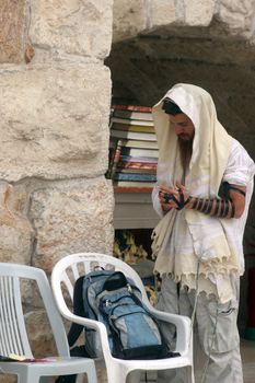 Jewish men pray at the western wall October 03, 2006 in Jerusalem, IL. The wall is one of the holiest sites in Judaism attracting thousands of worshipers daily.