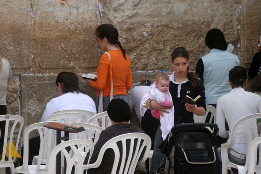 Jewish woman pray at the western wall October 03, 2006 in Jerusalem, IL. The wall is one of the holiest sites in Judaism attracting thousands of worshipers daily.